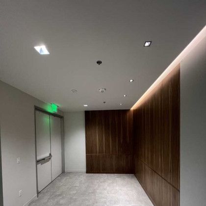 A long hallway with a wooden wall and a ceiling.