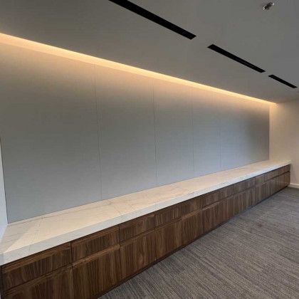 There is a long wooden bench in the middle of the room.