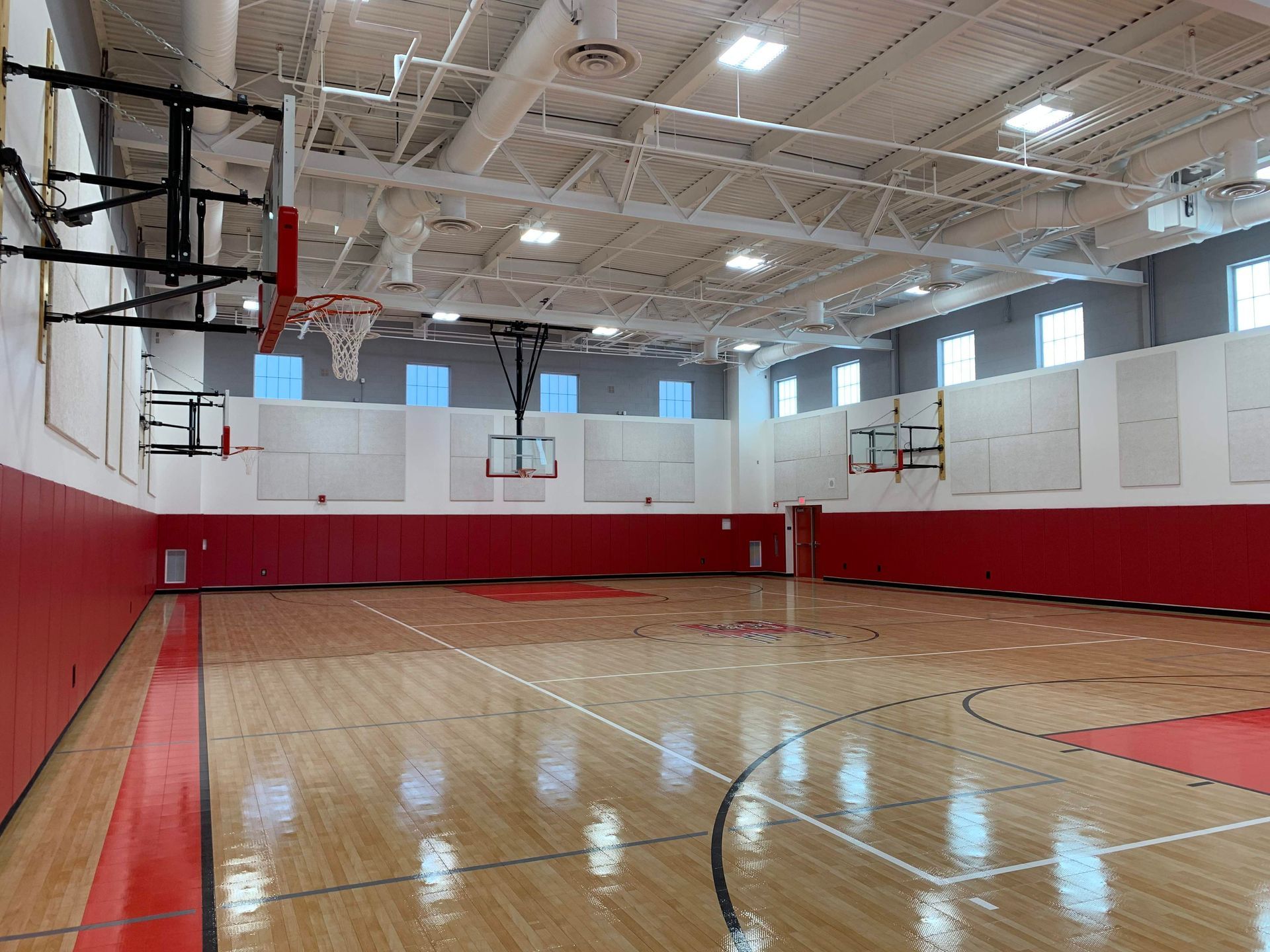 There is a basketball court in the middle of the gym.