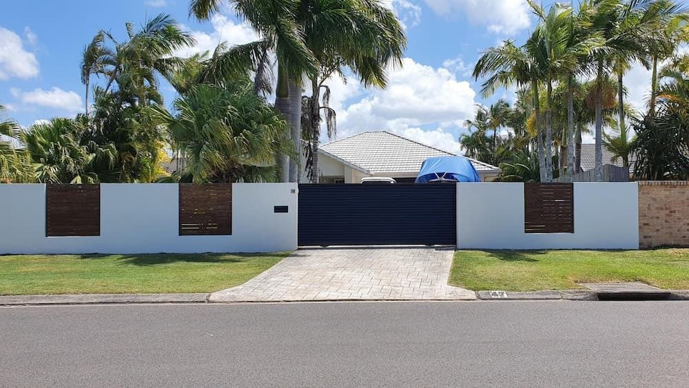 A House with A White Fence and A Black Gate Is Surrounded by Palm Trees — MJ Render in Buderim, QLD