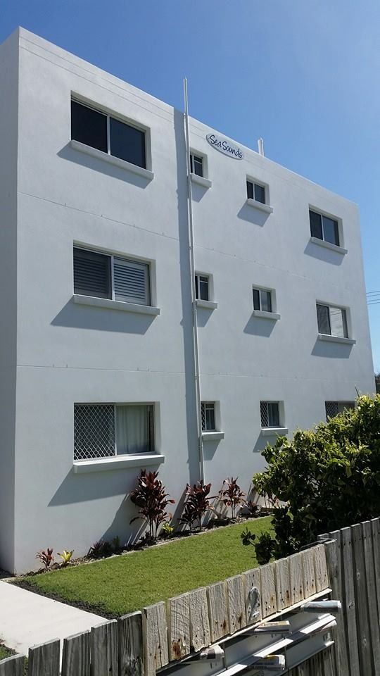 A Large White Building with A Lot of Windows and A Wooden Fence — MJ Render in Buderim, QLD