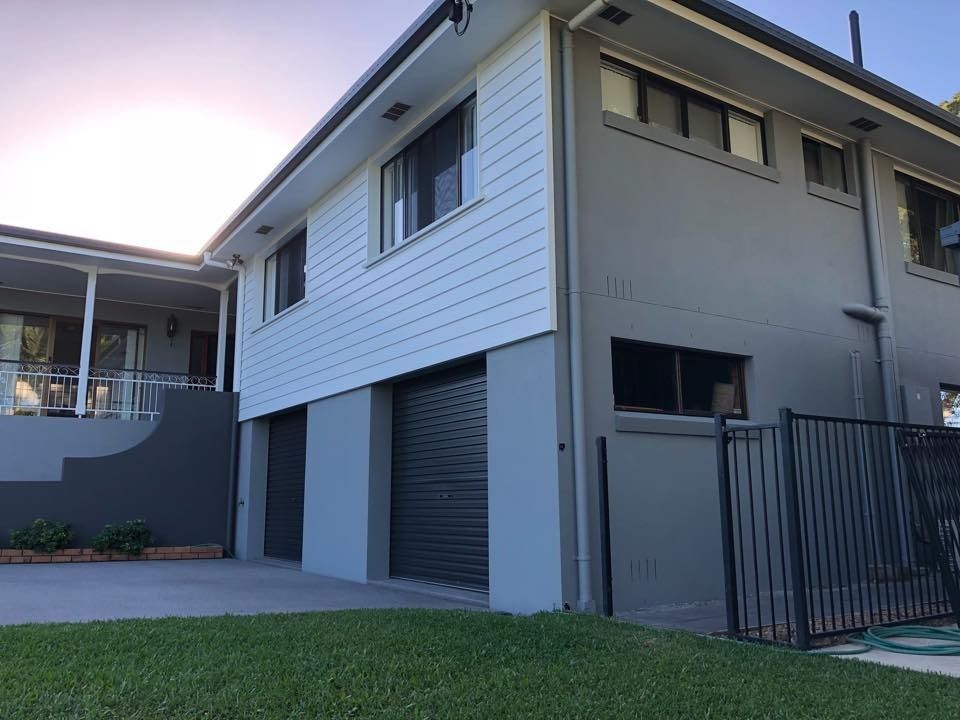 A large House with A Garage and A Fence in Front of It — MJ Render in Buderim, QLD