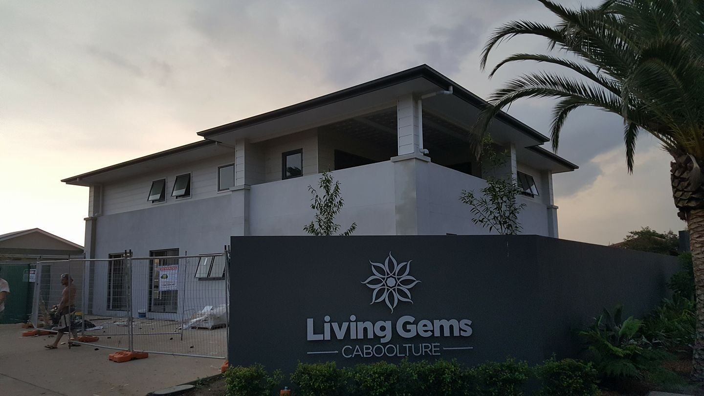 A Building Under Construction with A Sign that Says Living Gems on It — MJ Render in Buderim, QLD
