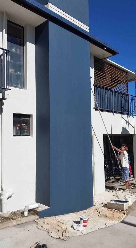 A Man Is Painting a Blue Wall of A House  — MJ Render in Buderim, QLD
