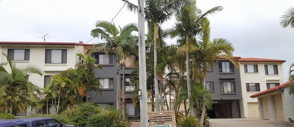 A Large Apartment Building with Palm Trees in Front of It  — MJ Render in Buderim, QLD