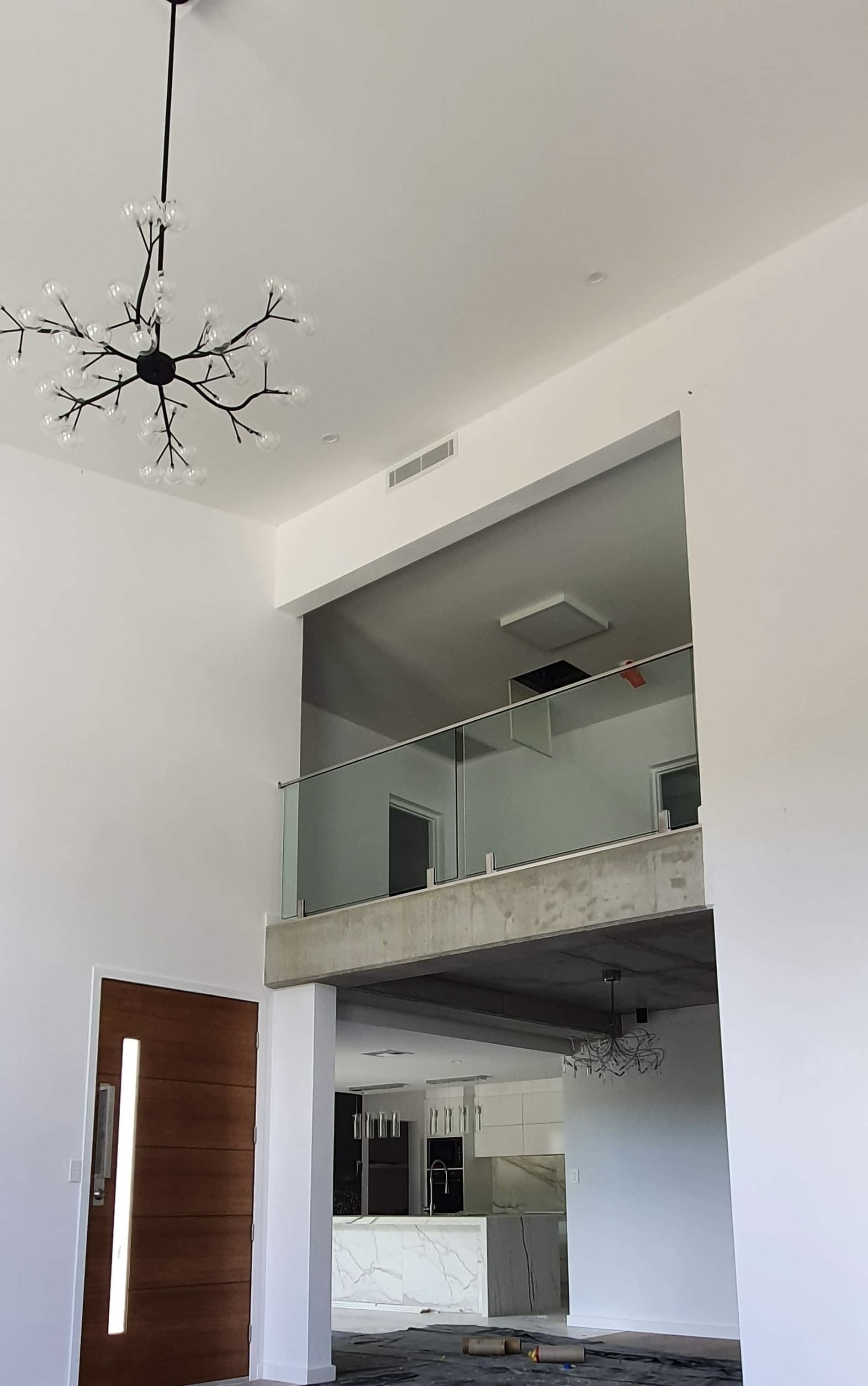A Large Room with A Balcony and A Chandelier Hanging from The Ceiling — MJ Render in Buderim, QLD