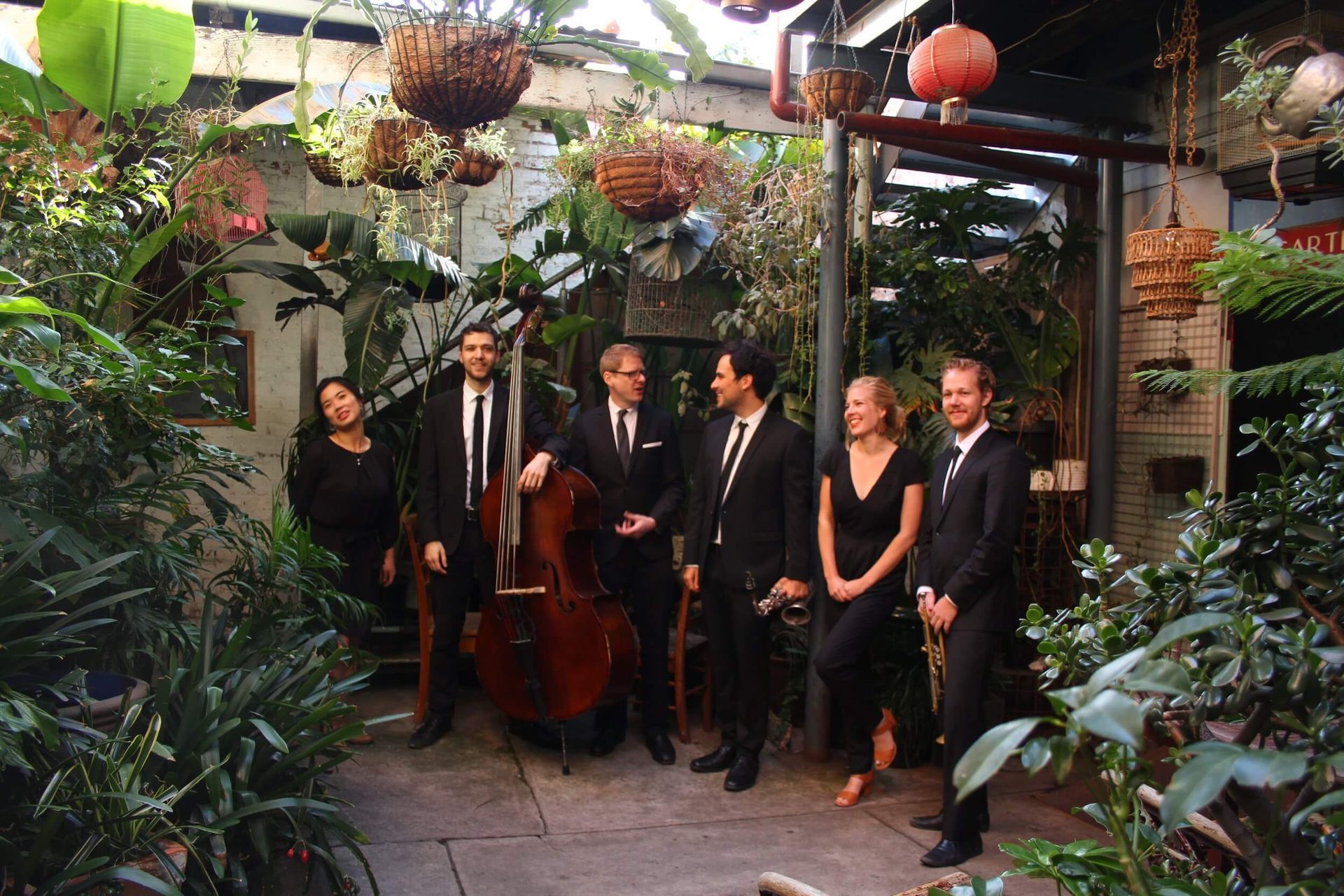A group of people standing next to each other in a garden