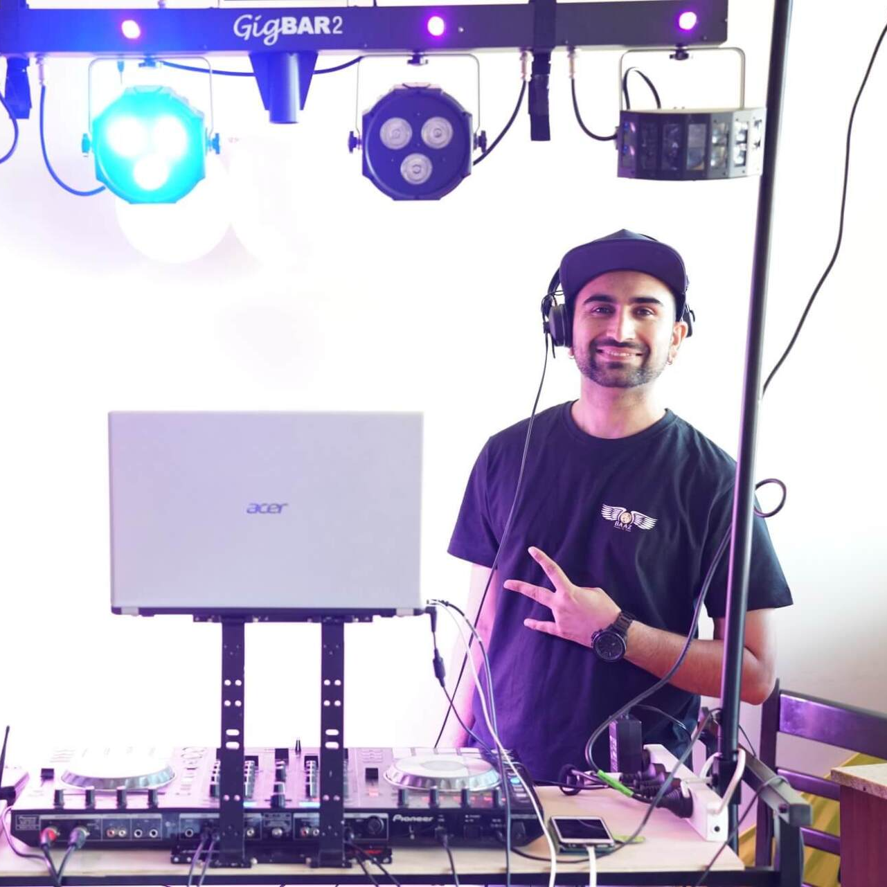 Professional Melbourne DJ setting up sound and lighting equipment for event