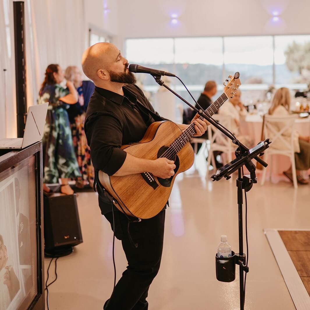 Isaac singing at an event in Hobart