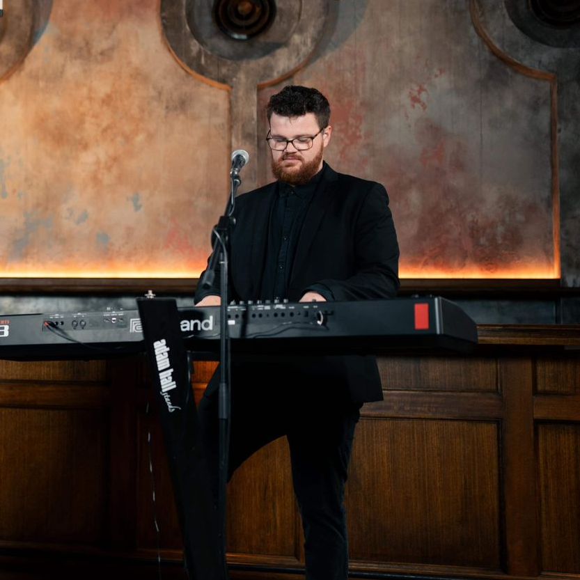 Jack playing piano with a live funk and soul band in Melbourne