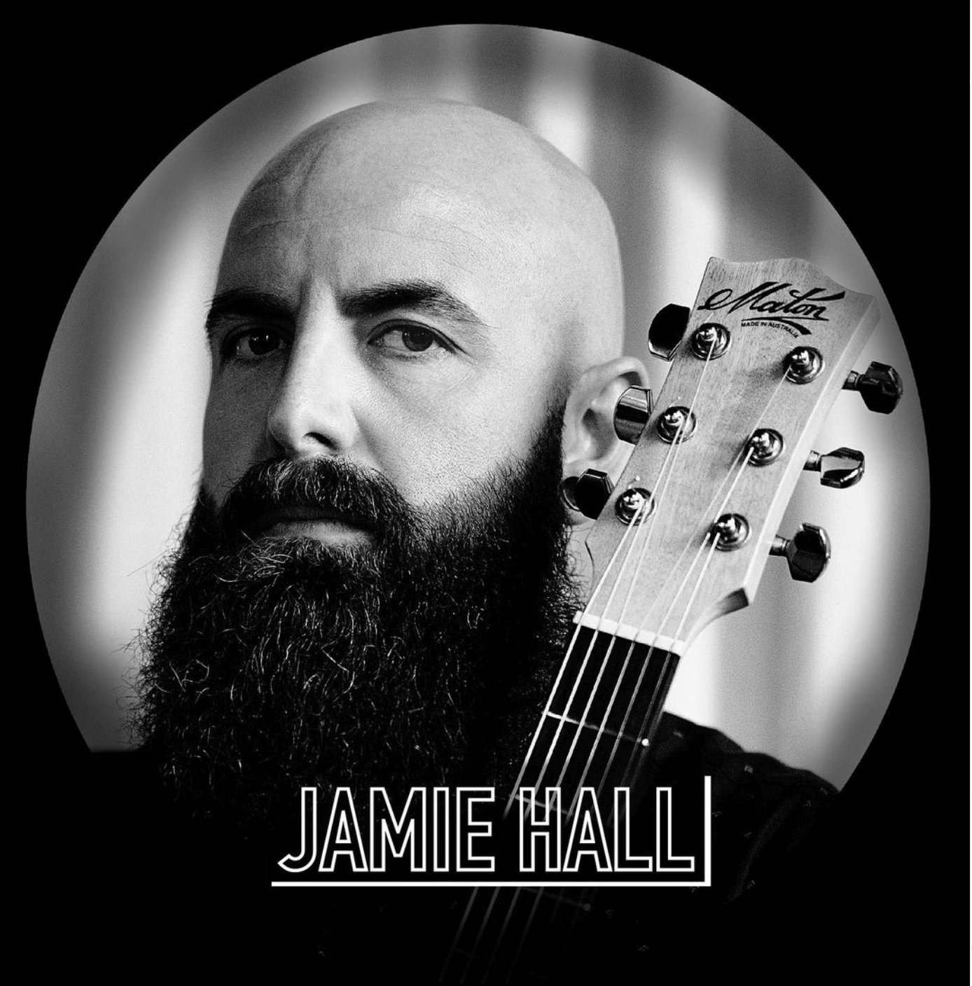 Jamie, bald man with a full beard, holding a guitar. Black and white, oval frame.