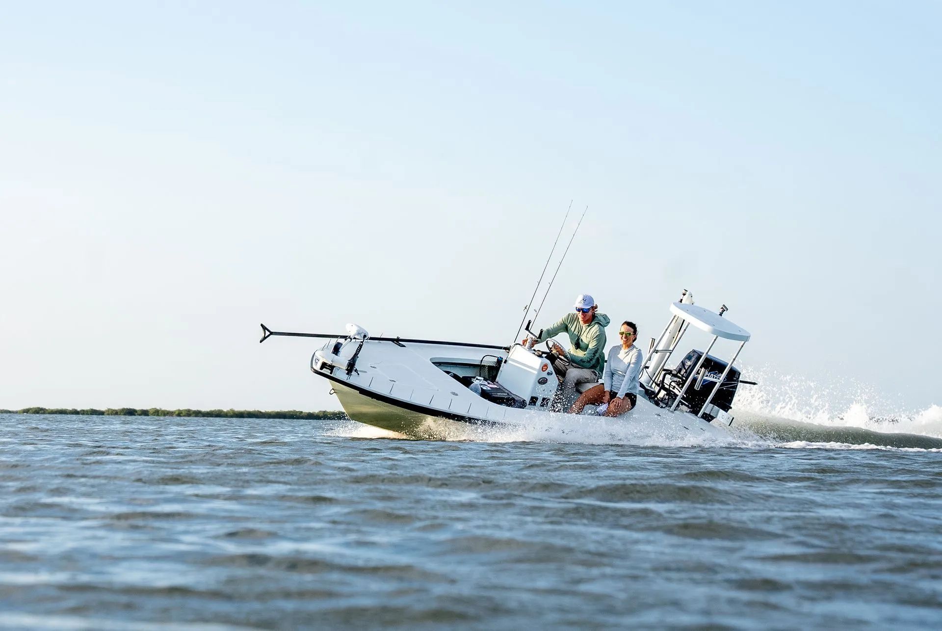 Small fishing boat capsizing in rough water with people aboard and fishing rods visible