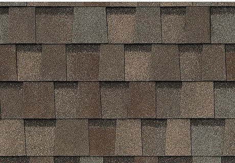 Brown asphalt roof shingles in a repeating pattern