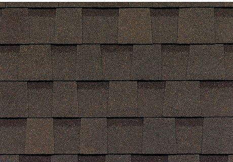 Close-up of dark brown roof shingles arranged in horizontal rows.