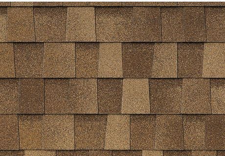 Close-up of brown asphalt roof shingles in a repeating pattern