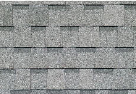 Gray asphalt roof shingles in a close-up pattern.