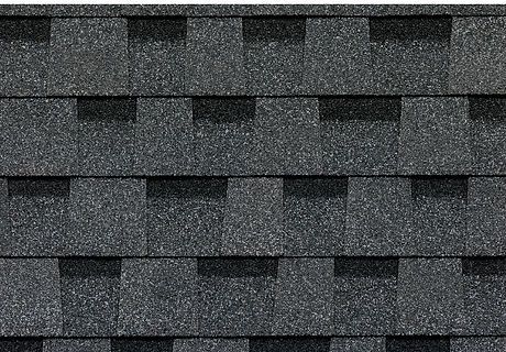 Dark gray asphalt roof shingles with a repeating overlapping pattern