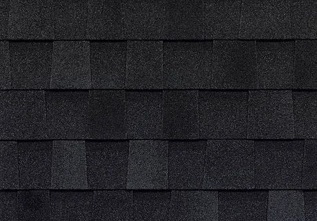 Dark gray asphalt shingles arranged in horizontal rows on a roof.
