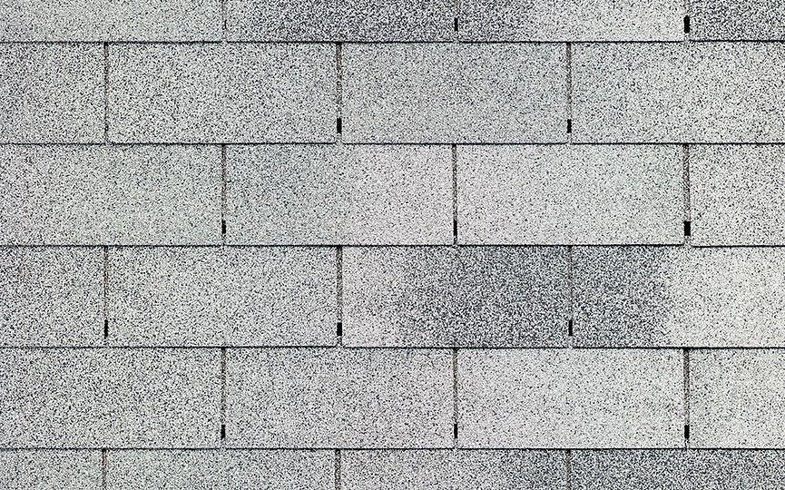 A close up of a row of gray shingles on a roof.
