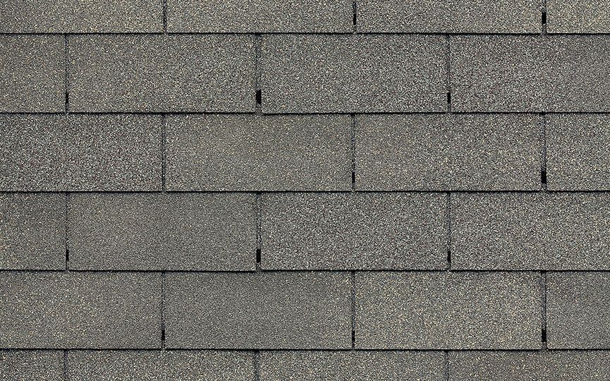 A close up of a row of gray shingles on a roof.