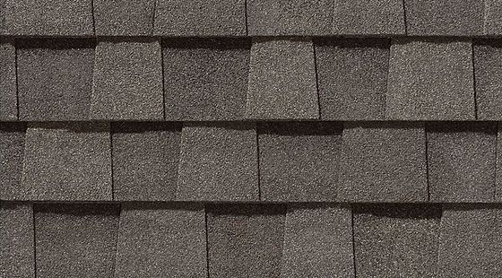 Close-up of gray asphalt roof shingles in horizontal rows