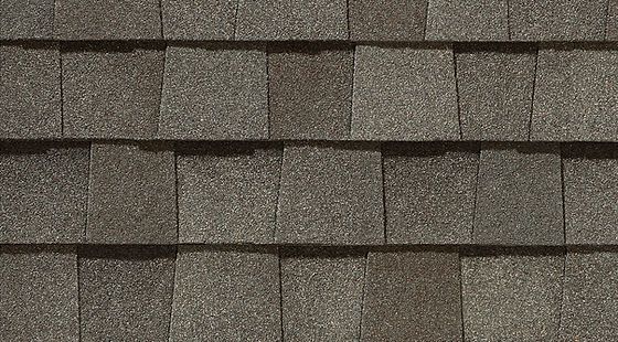 Close-up of gray-brown asphalt roof shingles in horizontal rows