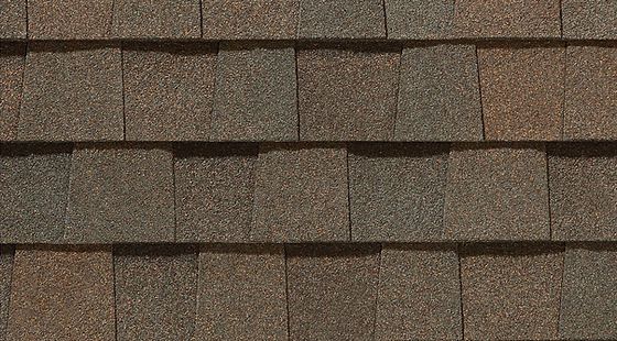 Brown asphalt roof shingles in a close-up pattern.