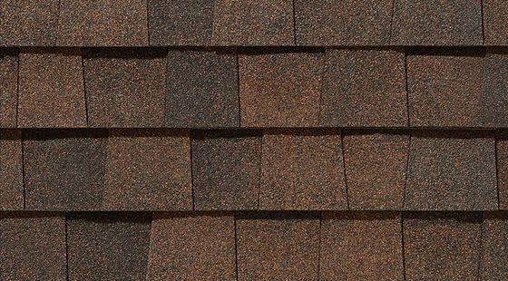 Close-up of brown asphalt roof shingles in horizontal rows