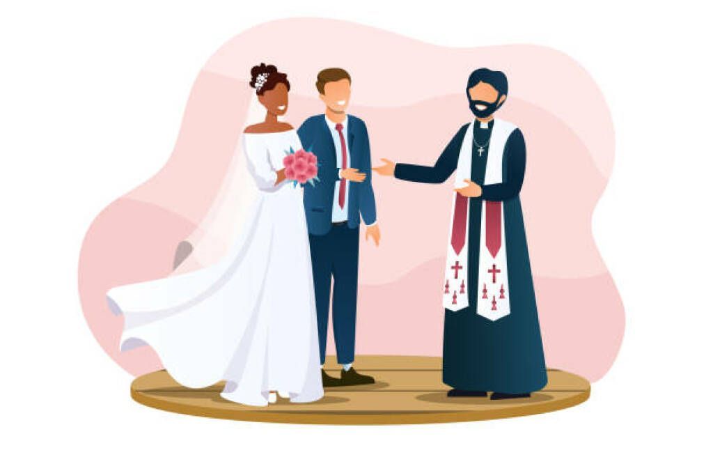 Bride, groom, and officiant at a wedding ceremony under a pink backdrop