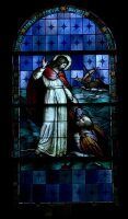 Stained-glass window showing a white-robed figure beside a seated person in a blue-toned scene