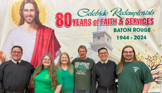 Group posing under banner celebrating 80 years of faith and service, Baton Rouge 1944–2024
