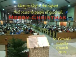 Crowded church interior with Christmas banner and choir loft, St. Gerard’s major church 2019