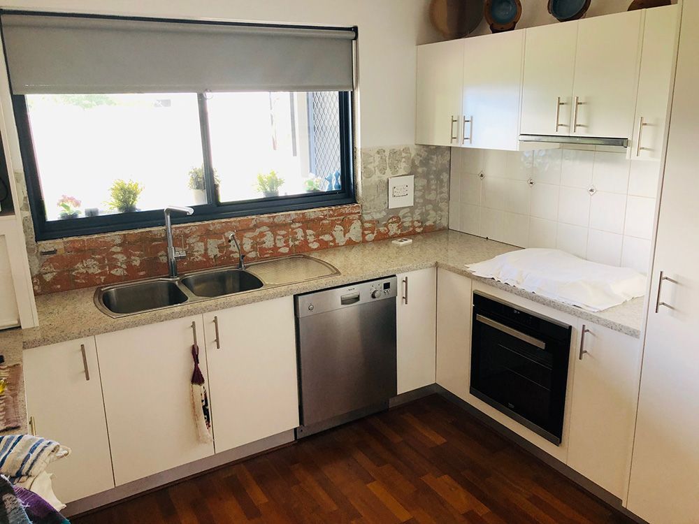 White Kitchen With Stainless Steel Appliances, And An Aluminum Window — Ace Glass & Aluminium In Grafton, NSW