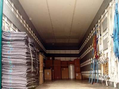 Interno di un camion per traslochi pieno di imbottiture, scatole e oggetti vari accatastati.