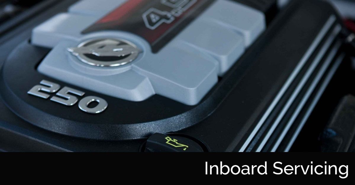 Close-up of a black engine cover labeled 250 with “Inboard Servicing” text overlay