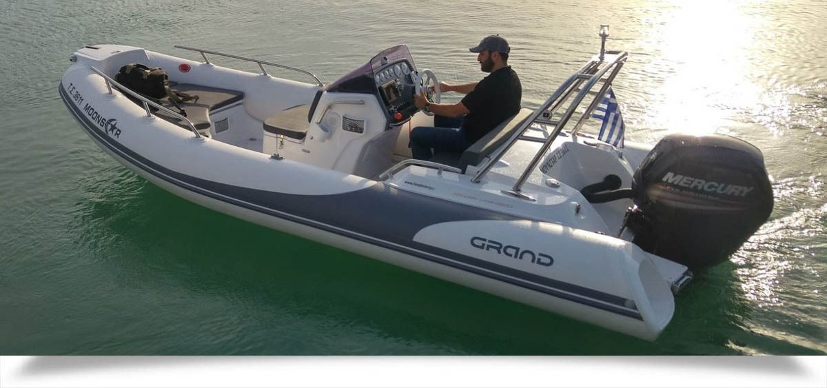 Small white motorboat on green water with two people aboard and an outboard engine at the stern