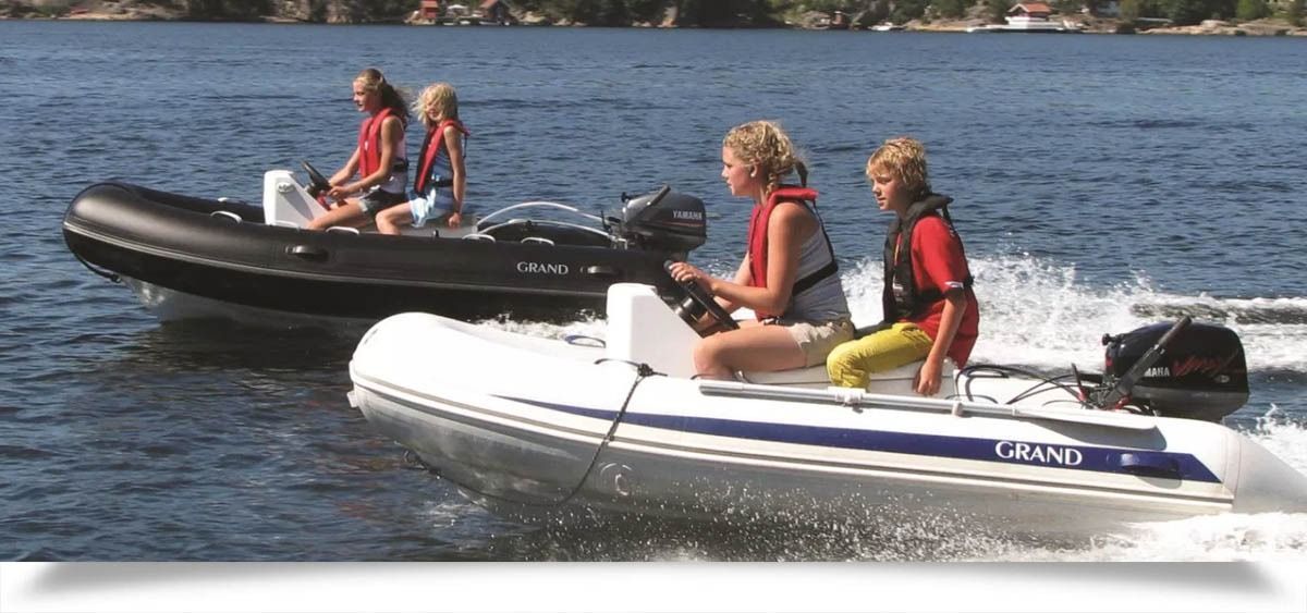 Two inflatable boats with people riding on a lake on a sunny day