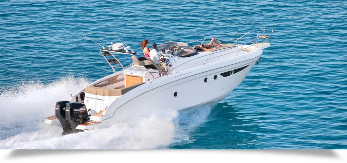 White motor boat speeding across blue water, leaving a foamy wake with passengers onboard