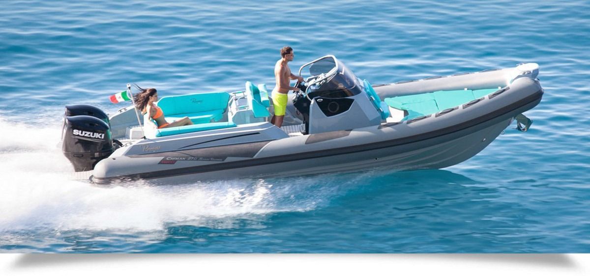 Inflatable speedboat on calm blue water with people relaxing aboard and a dog near the stern