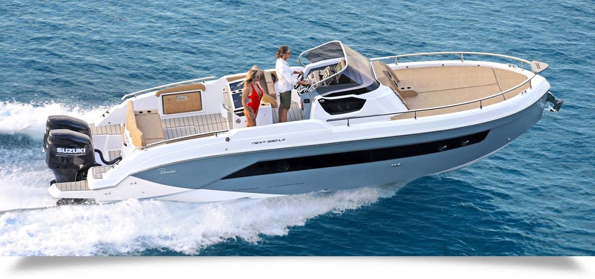 White Ranieri next 330 speedboat cruising on blue water with two people on deck