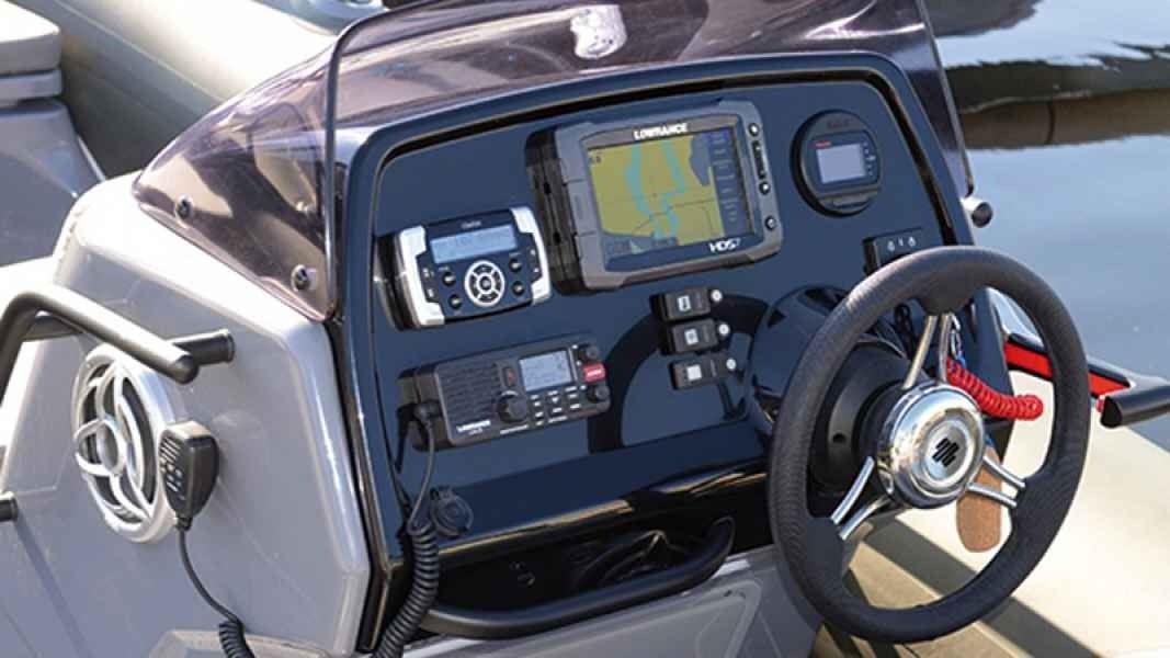 grand golden line 500 Boat cockpit with steering wheel, control panel, and navigation display.