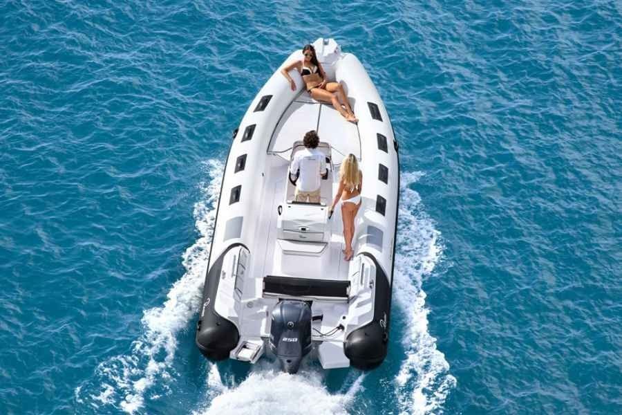 Inflatable ranieri cayman 26 sport motorboat with people aboard moving through bright blue water