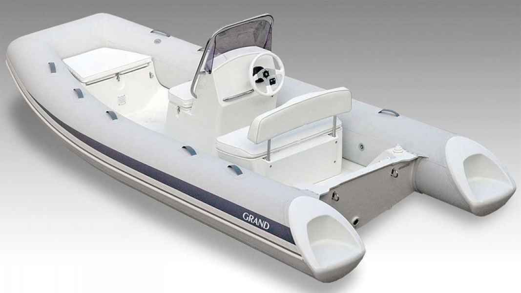 White inflatable grand silver line 470 pontoon boat with seats and steering console on a plain background