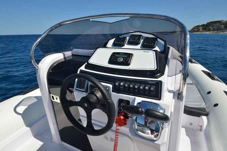 Ranieri Cayman 31 Sport Touring Rib Boat helm with steering wheel, dashboard, and windshield on the open water