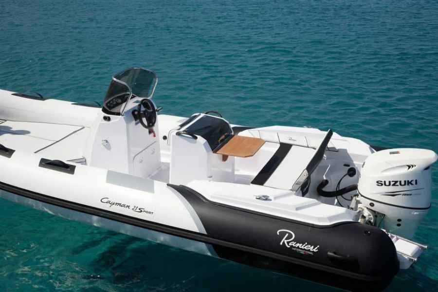 White and black RIB grand silver line 370 motorboat on turquoise water with twin Suzuki outboard engines