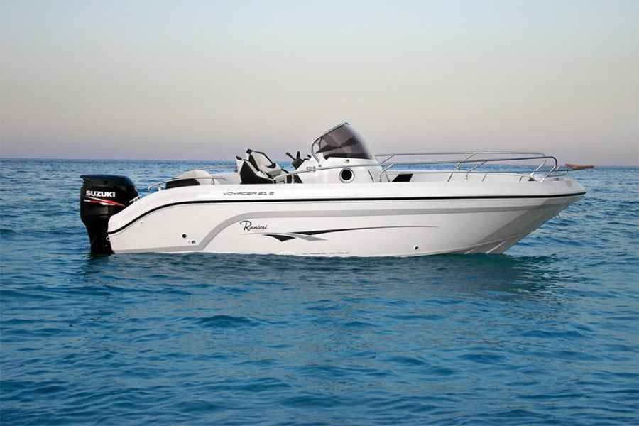 White ranieri voyager 21 Sport motorboat cruising on calm blue water at sunset with an outboard engine and canopy