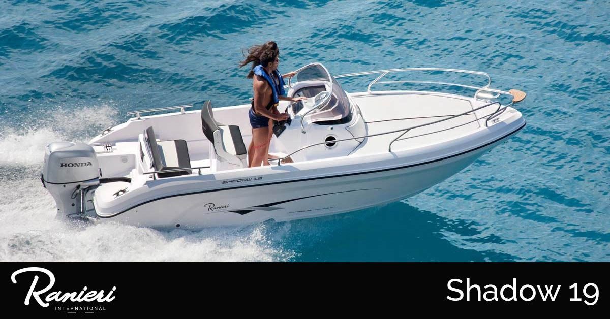White ranieri Shadow 19 speedboat on turquoise water, with a person standing at the helm