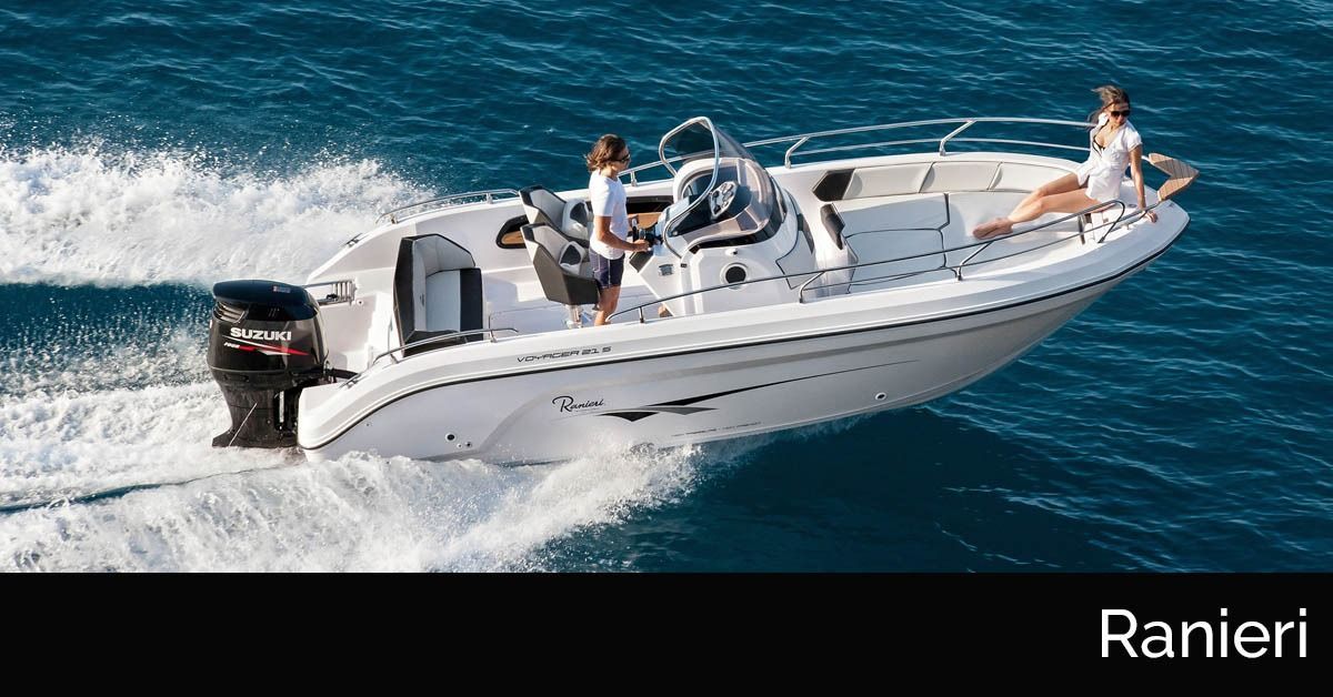 White Ranieri speedboat cruising on blue water with several passengers aboard