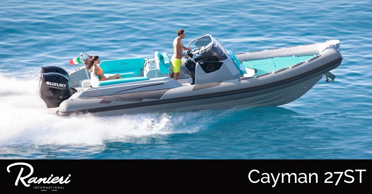 Three people ride in a gray-and-white RIB boat on calm blue water, labeled Caymen 27ST.
