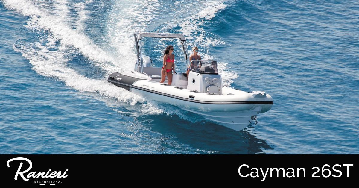 White RIB speedboat with two people cruising on blue water, leaving a wake
